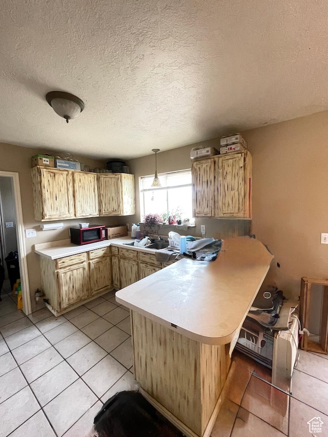 3301 S 1500 E, Vernal, UT 84078 - kitchen with a peninsula, light countertops, light tile patterned flooring, a textured ceiling, and hanging light fixtures