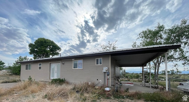 3301 S 1500 E, Vernal, UT 84078 - rear view of property with an attached carport, metal roof, and a patio