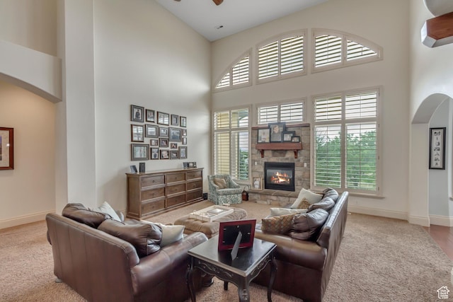 6663 W Normandy Way, Highland, UT 84003 - living area with a towering ceiling, carpet, arched walkways, baseboards, and a ceiling fan