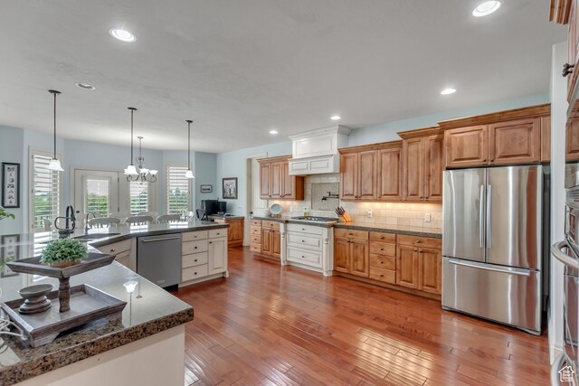 6663 W Normandy Way, Highland, UT 84003 - kitchen featuring stainless steel appliances, plenty of natural light, tasteful backsplash, light wood-type flooring, and recessed lighting