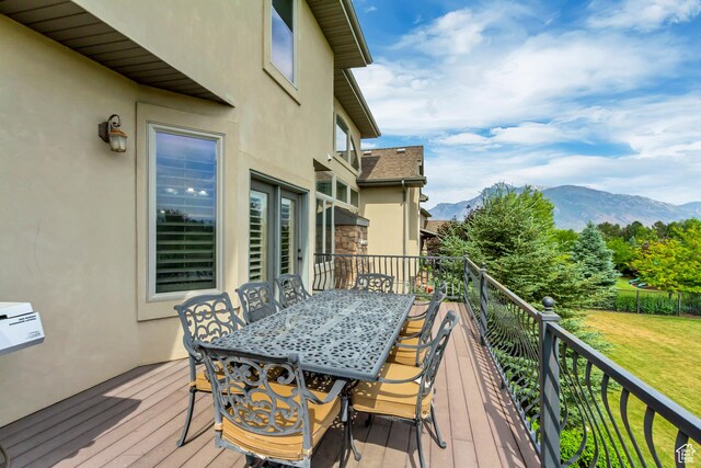 6663 W Normandy Way, Highland, UT 84003 - wooden deck with a mountain view, a yard, and outdoor dining space
