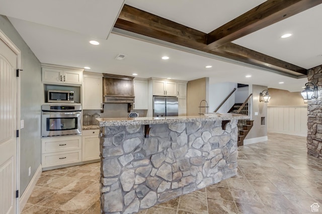 6663 W Normandy Way, Highland, UT 84003 - kitchen with appliances with stainless steel finishes, light stone countertops, a breakfast bar, recessed lighting, and wainscoting