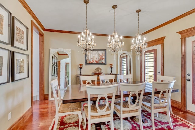 6663 W Normandy Way, Highland, UT 84003 - dining room featuring a chandelier, crown molding, wood finished floors, arched walkways, and baseboards