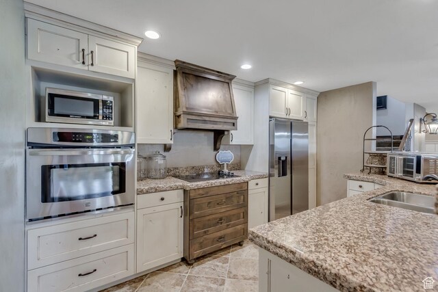 6663 W Normandy Way, Highland, UT 84003 - kitchen featuring stainless steel appliances, premium range hood, white cabinetry, a sink, and light stone counters