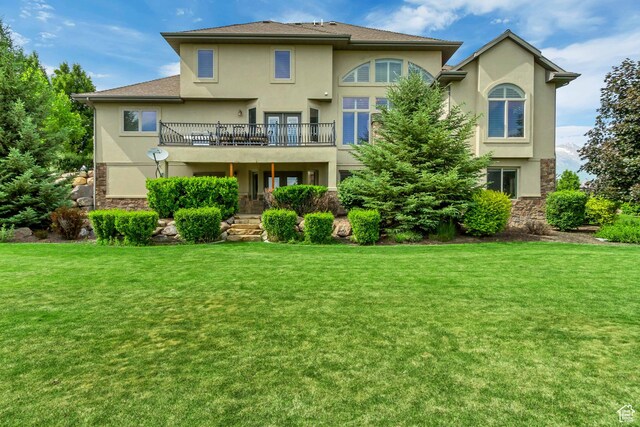 6663 W Normandy Way, Highland, UT 84003 - back of property with stucco siding and a yard