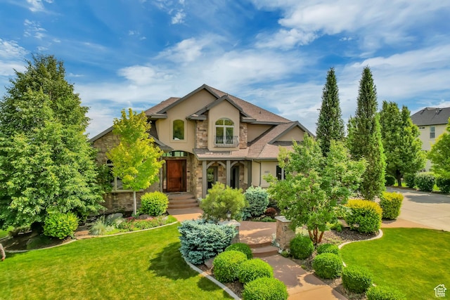6663 W Normandy Way, Highland, UT 84003 - view of front facade featuring stucco siding, stone siding, and a front lawn
