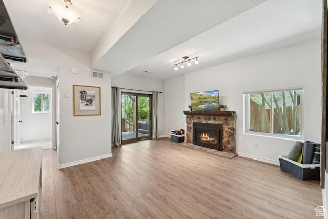 8086 N Meadowview Dr, Snyderville, UT 84098 - unfurnished living room featuring wood finished floors, a fireplace, plenty of natural light, and baseboards