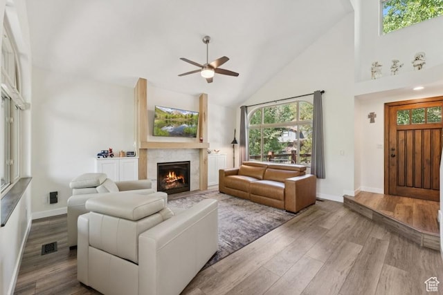 8086 N Meadowview Dr, Snyderville, UT 84098 - living area with ceiling fan, high vaulted ceiling, a warm lit fireplace, wood finished floors, and baseboards