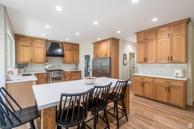 1110 S Woodland Hills Dr, Woodland Hills, UT 84653 - kitchen with appliances with stainless steel finishes, premium range hood, tasteful backsplash, a breakfast bar, and recessed lighting
