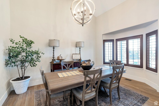 1110 S Woodland Hills Dr, Woodland Hills, UT 84653 - dining room featuring baseboards, wood finished floors, a chandelier, and a towering ceiling