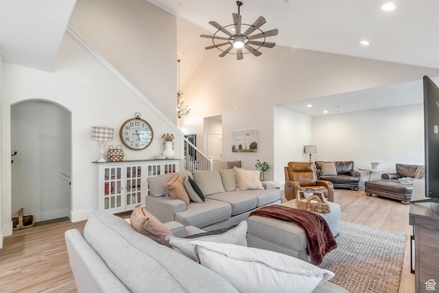 1110 S Woodland Hills Dr, Woodland Hills, UT 84653 - living area featuring a ceiling fan, stairway, arched walkways, light wood-style flooring, and high vaulted ceiling