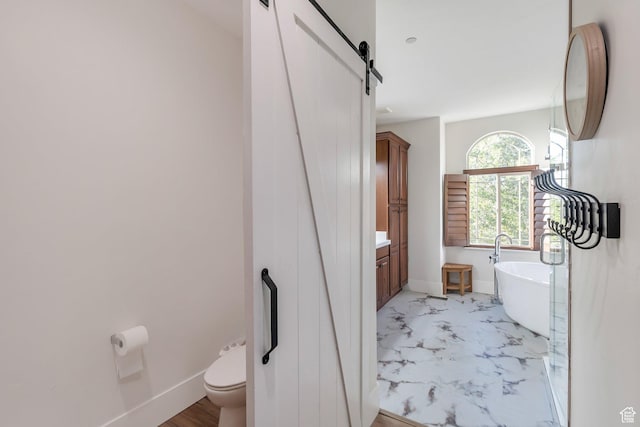1110 S Woodland Hills Dr, Woodland Hills, UT 84653 - full bath with a soaking tub, toilet, marble finish flooring, vanity, and baseboards