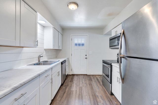 129 N 1100 W, Provo, UT 84601 - kitchen featuring appliances with stainless steel finishes, a sink, white cabinets, and dark wood-style flooring