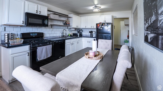 4820 S 4900 W, Kearns, UT 84118 - kitchen with black appliances, dark countertops, backsplash, a sink, and white cabinetry