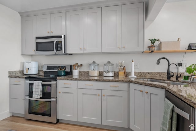 1146 S 2880 E, Spanish Fork, UT 84660 - kitchen with appliances with stainless steel finishes, light wood-style floors, stone counters, and open shelves