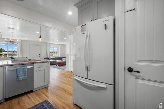 1146 S 2880 E, Spanish Fork, UT 84660 - kitchen with freestanding refrigerator, dishwasher, light wood-style floors, recessed lighting, and open floor plan