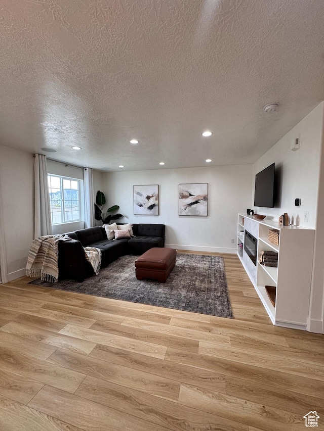 1146 S 2880 E, Spanish Fork, UT 84660 - living room featuring a textured ceiling, recessed lighting, and wood finished floors