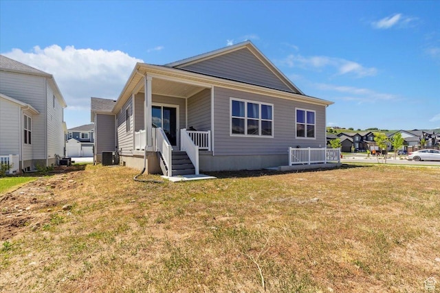 5936 N Angels Landing Dr, Mountain Green, UT 84050 - back of house with cooling unit, a yard, and a residential view