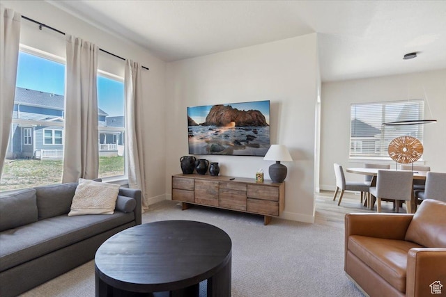 5936 N Angels Landing Dr, Mountain Green, UT 84050 - living room featuring plenty of natural light, light colored carpet, and baseboards