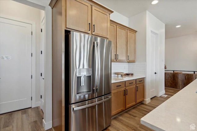 5936 N Angels Landing Dr, Mountain Green, UT 84050 - kitchen featuring stainless steel fridge with ice dispenser, wood finished floors, light countertops, decorative backsplash, and recessed lighting