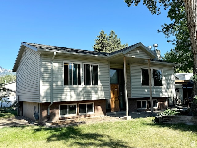 8731 S Gladiator Way, Sandy, UT 84094 - rear view of house with a yard, a chimney, and brick siding