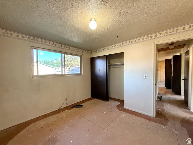 8731 S Gladiator Way, Sandy, UT 84094 - unfurnished bedroom featuring baseboards, a textured ceiling, and a closet