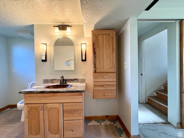 8731 S Gladiator Way, Sandy, UT 84094 - bathroom featuring baseboards, vanity, toilet, and a textured ceiling