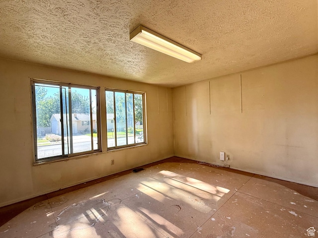 8731 S Gladiator Way, Sandy, UT 84094 - empty room featuring a textured ceiling and plenty of natural light