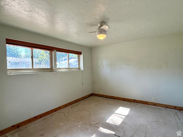 8731 S Gladiator Way, Sandy, UT 84094 - unfurnished room with baseboards, a ceiling fan, and a textured ceiling