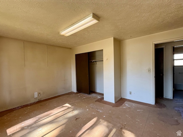 8731 S Gladiator Way, Sandy, UT 84094 - unfurnished bedroom featuring a textured ceiling, a closet, and baseboards