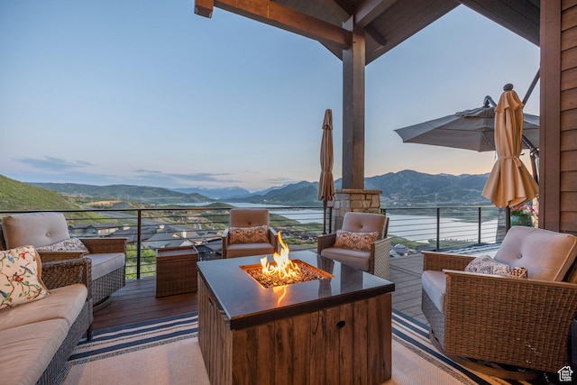 1136 E Black Hawk Way, Hideout, UT 84036 - deck with a mountain view and an outdoor living space with a fire pit
