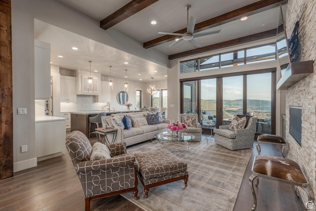 1136 E Black Hawk Way, Hideout, UT 84036 - living room featuring a ceiling fan, wood finished floors, beam ceiling, recessed lighting, and a chandelier