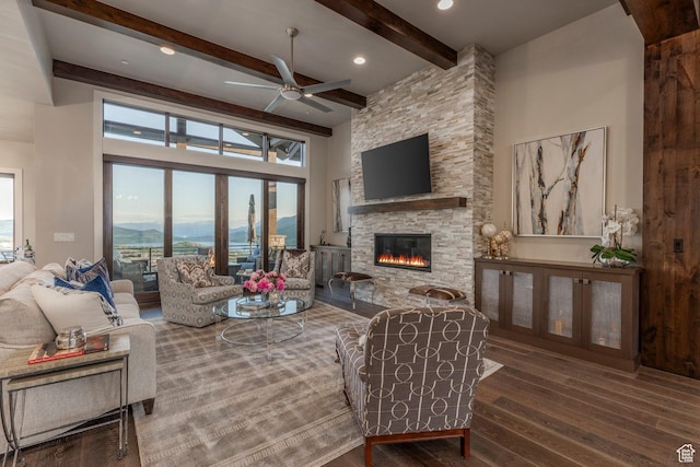 1136 E Black Hawk Way, Hideout, UT 84036 - living room with wood finished floors, a fireplace, beamed ceiling, a ceiling fan, and a high ceiling