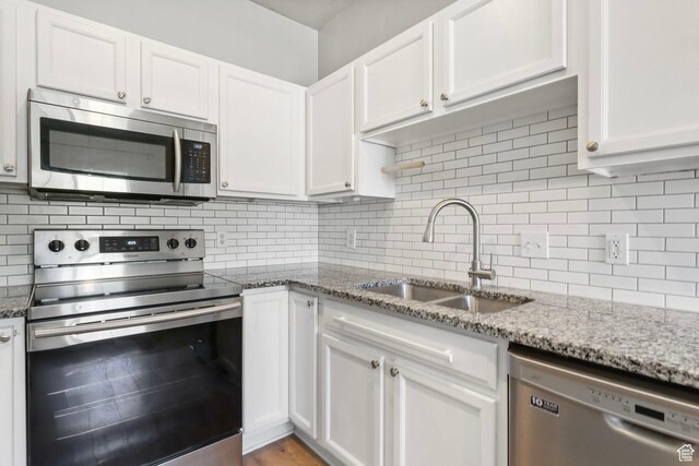 2108 W 2180 N, Lehi, UT 84043 - kitchen with appliances with stainless steel finishes, a sink, white cabinetry, and backsplash