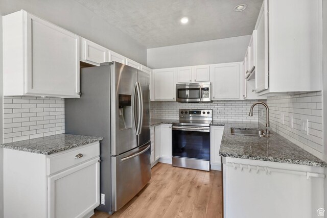 2108 W 2180 N, Lehi, UT 84043 - kitchen featuring stainless steel appliances, a sink, decorative backsplash, stone countertops, and recessed lighting