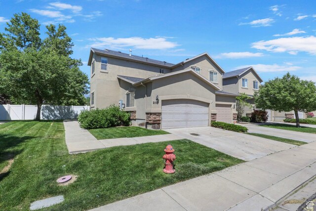 2108 W 2180 N, Lehi, UT 84043 - view of front of home featuring stucco siding, driveway, stone siding, and an attached garage