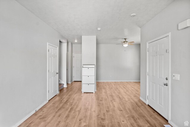 2108 W 2180 N, Lehi, UT 84043 - unfurnished living room featuring ceiling fan, light wood-style floors, and baseboards