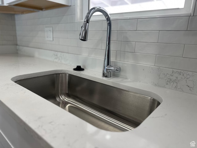 231 S 100th Ave E Unit 231, Willard, UT 84340 - kitchen view of a sink, decorative backsplash, and light stone countertops
