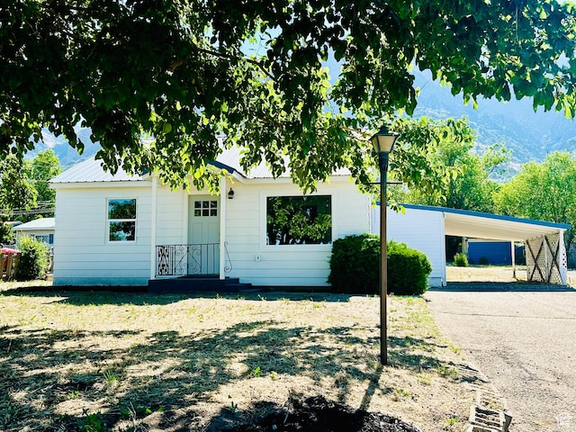 231 S 100th Ave E Unit 231, Willard, UT 84340 - view of front of home with concrete driveway, a carport, and a mountain view