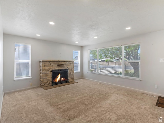 5147 S 2200 W, Salt Lake City, UT 84129 - unfurnished living room with carpet, baseboards, a stone fireplace, and recessed lighting