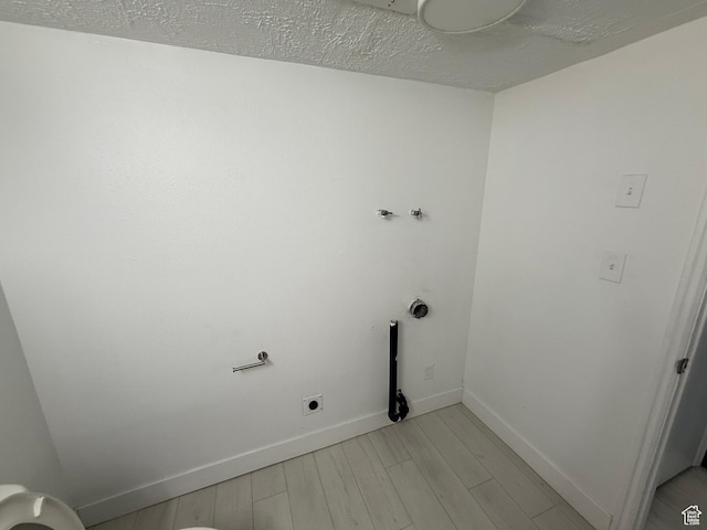 1071 N 150 W, Orem, UT 84057 - laundry room featuring hookup for an electric dryer, light wood-style floors, and a textured ceiling