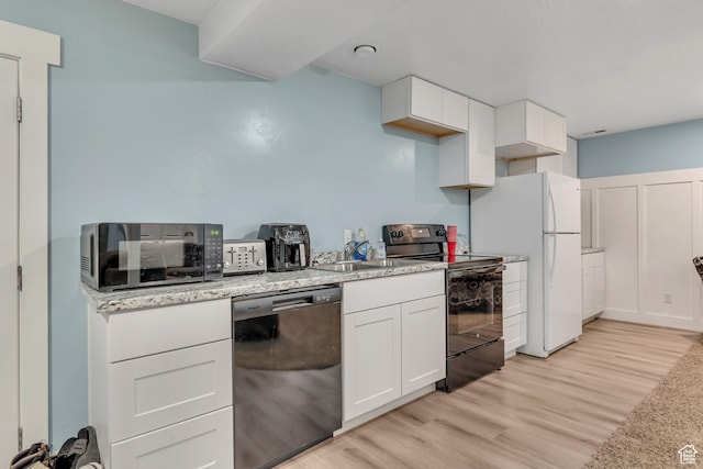 719 E Center St, Genola, UT 84655 - kitchen with dishwashing machine, black range with electric cooktop, freestanding refrigerator, light wood-type flooring, and white cabinets
