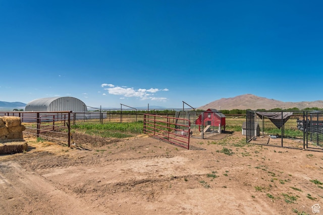 719 E Center St, Genola, UT 84655 - view of yard with an outdoor structure, a rural view, a detached garage, and a mountain view