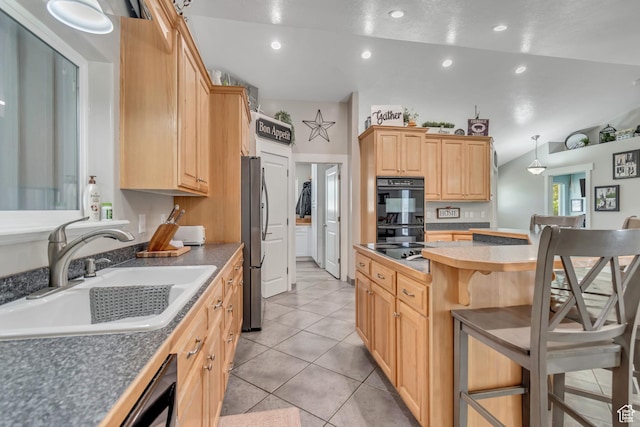 719 E Center St, Genola, UT 84655 - kitchen featuring a sink, black appliances, a breakfast bar area, light brown cabinets, and a center island