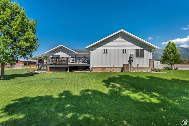 719 E Center St, Genola, UT 84655 - rear view of property featuring a wooden deck, a lawn, and central AC unit