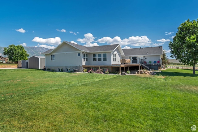 719 E Center St, Genola, UT 84655 - rear view of house with a wooden deck, a lawn, and stairs