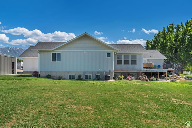 719 E Center St, Genola, UT 84655 - back of property featuring a deck, central AC, and a lawn