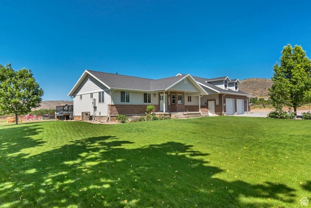 719 E Center St, Genola, UT 84655 - view of front of home featuring covered porch, a garage, and a front lawn