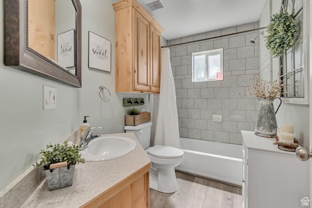 719 E Center St, Genola, UT 84655 - bathroom with toilet, wood finished floors, shower / bath combo, and vanity