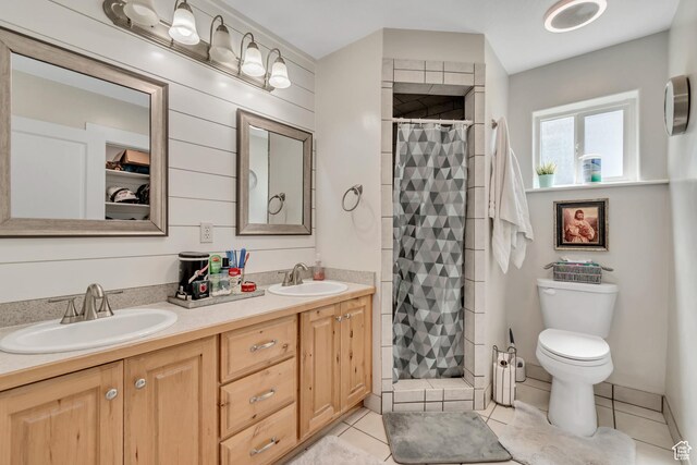 719 E Center St, Genola, UT 84655 - bathroom featuring a stall shower, double vanity, tile patterned floors, and toilet